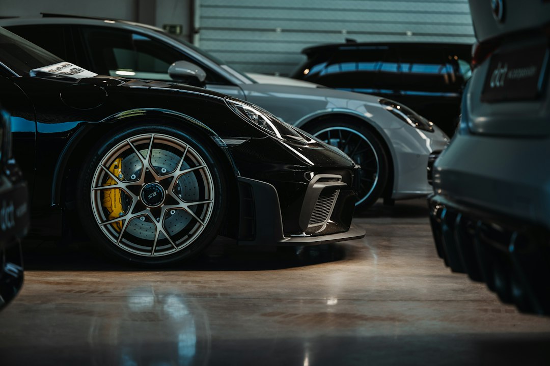 a-couple-of-cars-parked-next-to-each-other-in-a-garage-4xi6q0ge-eu
